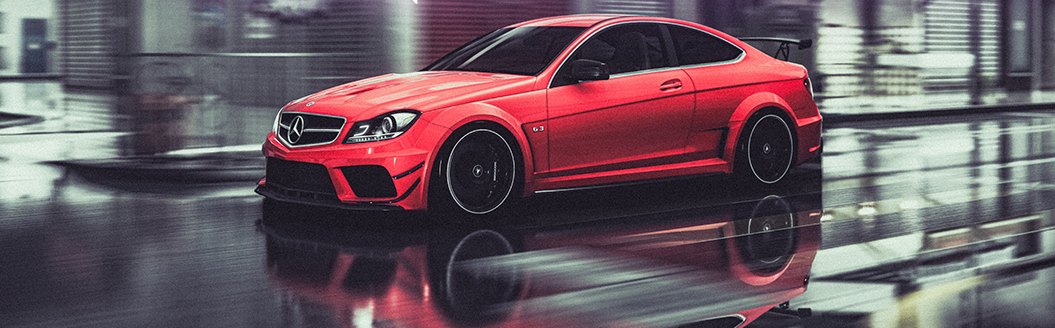 A red Mercedes C63 AMG Black Series standing on a wet garage floor.